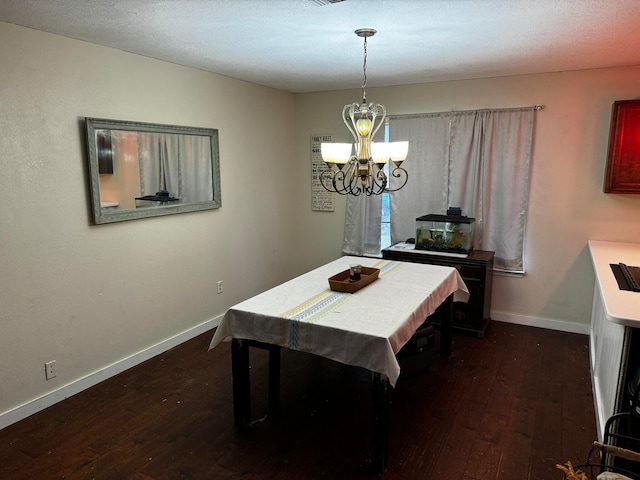 dining space featuring a chandelier, a textured ceiling, and dark hardwood / wood-style flooring