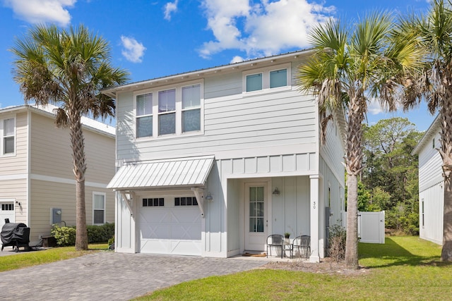 view of front of home with a garage and a front lawn