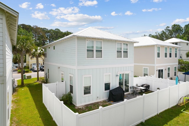 rear view of property with a yard