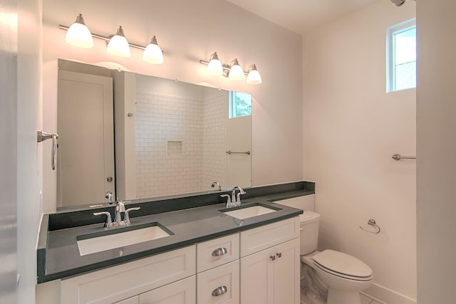 bathroom featuring vanity, a shower, and toilet