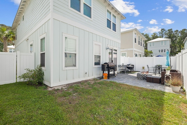 rear view of house featuring a patio and a lawn