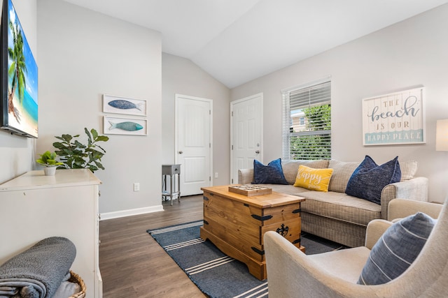 living room featuring lofted ceiling and dark hardwood / wood-style floors