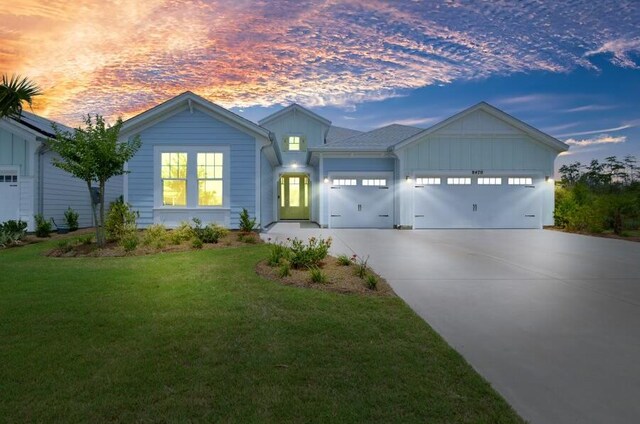 view of front facade with a garage and a yard