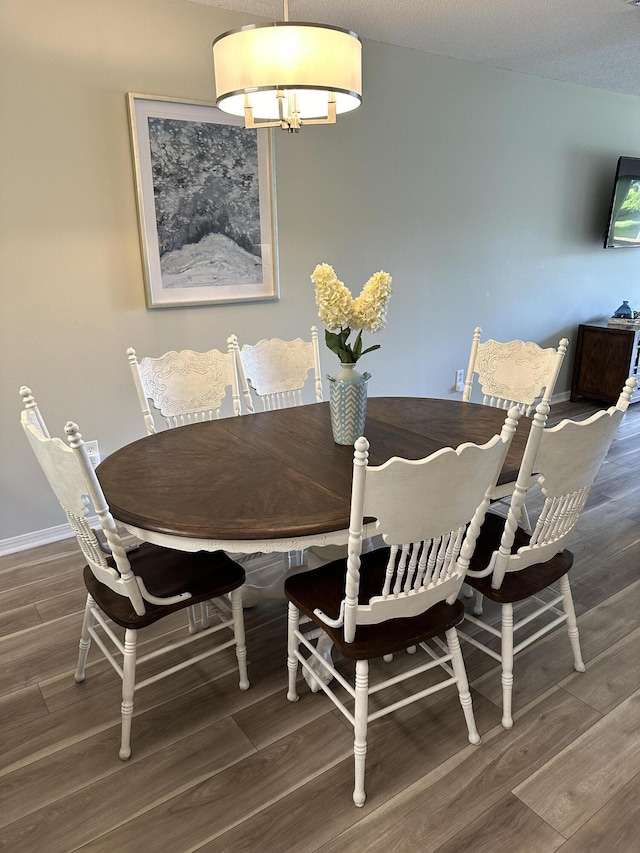 dining area with a notable chandelier and a textured ceiling