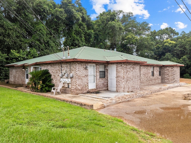 back of property with a patio and a lawn