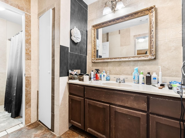 bathroom with vanity, tile patterned floors, and tile walls