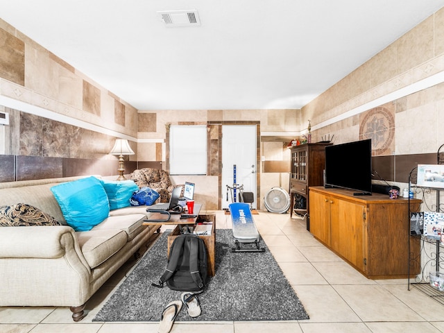 tiled living room featuring tile walls