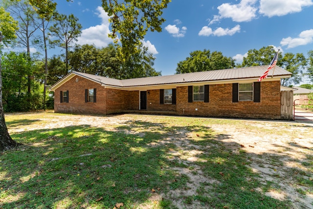 ranch-style home with a front lawn