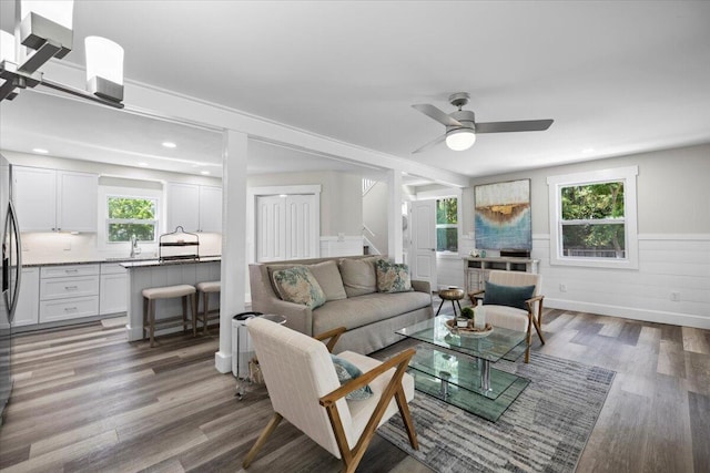 living room with wood-type flooring and ceiling fan