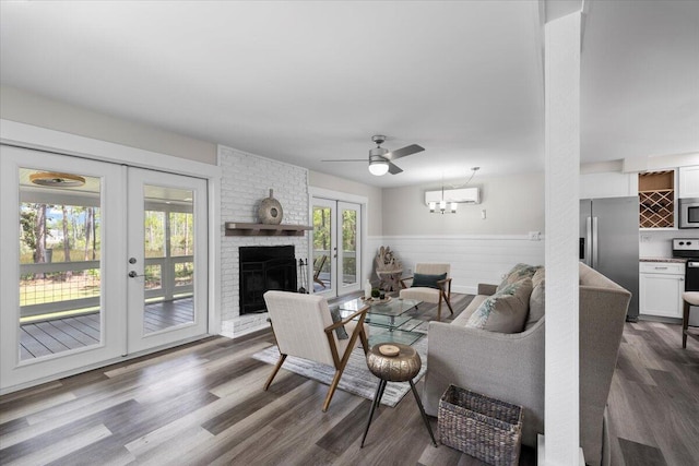 living room featuring a brick fireplace, dark hardwood / wood-style floors, ceiling fan, and french doors