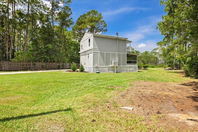 exterior space with a yard and a sunroom