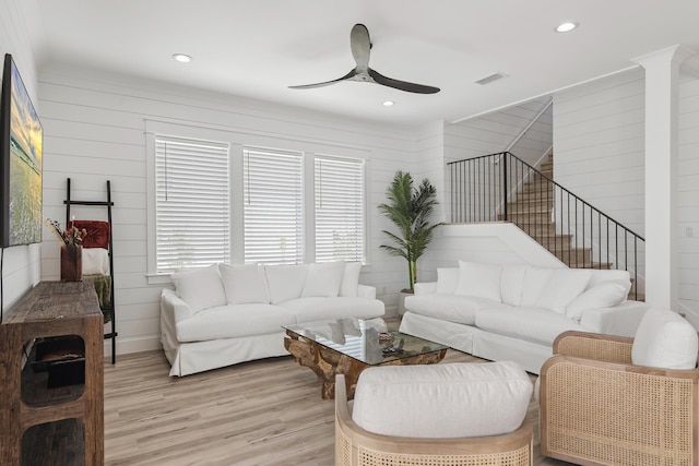 living room with light wood-type flooring and ceiling fan