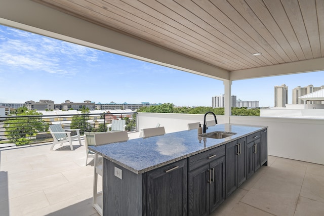 view of patio with a balcony and sink