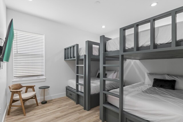 bedroom featuring multiple windows and light wood-type flooring