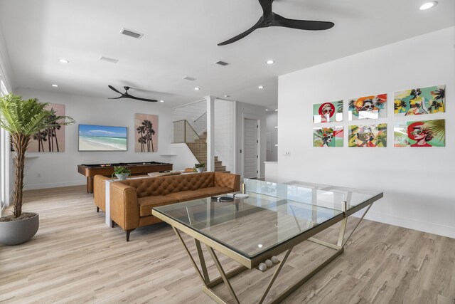 living room with light hardwood / wood-style flooring, ceiling fan, and billiards