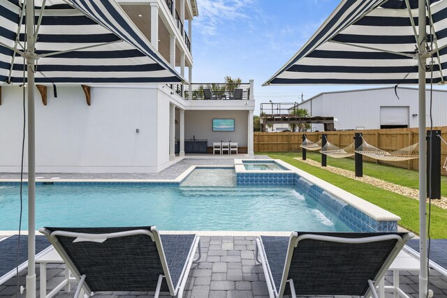 view of pool featuring a patio area, an in ground hot tub, and pool water feature