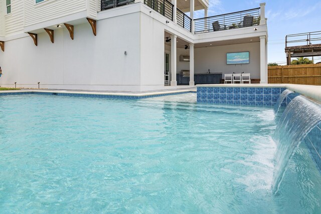 view of swimming pool with pool water feature