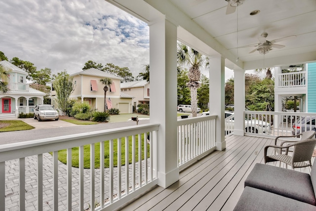 wooden deck featuring a porch and ceiling fan