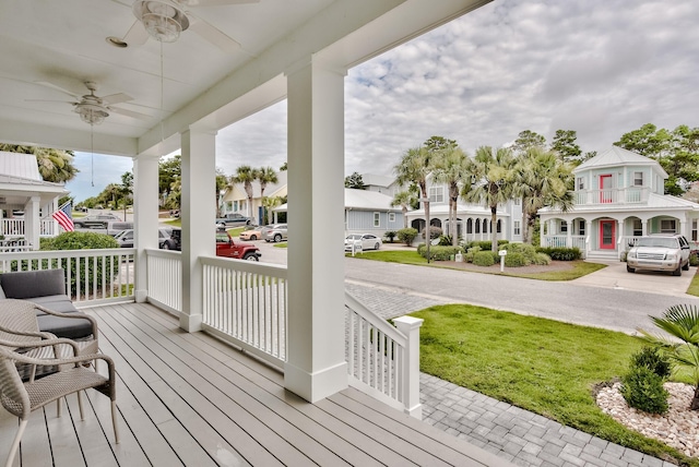 wooden terrace with ceiling fan and covered porch