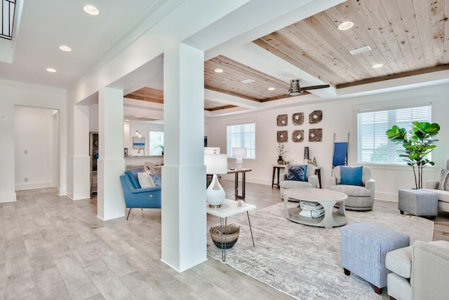 living room with a wealth of natural light, light hardwood / wood-style flooring, ceiling fan, and wood ceiling