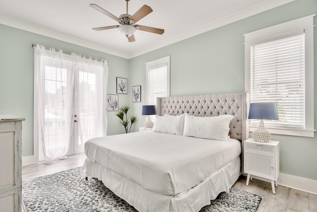 bedroom featuring ceiling fan, light hardwood / wood-style flooring, french doors, and ornamental molding