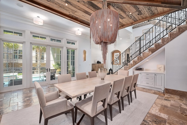 dining room with french doors, beamed ceiling, and wood ceiling