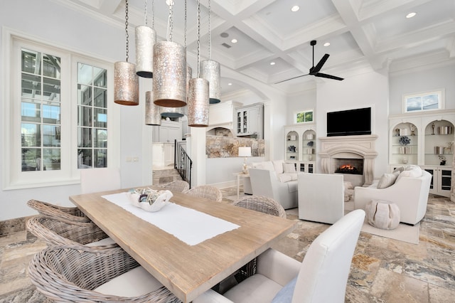 dining area featuring ceiling fan, coffered ceiling, a high ceiling, beamed ceiling, and crown molding