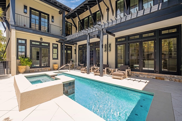 view of swimming pool with an in ground hot tub, french doors, a patio, and a pergola