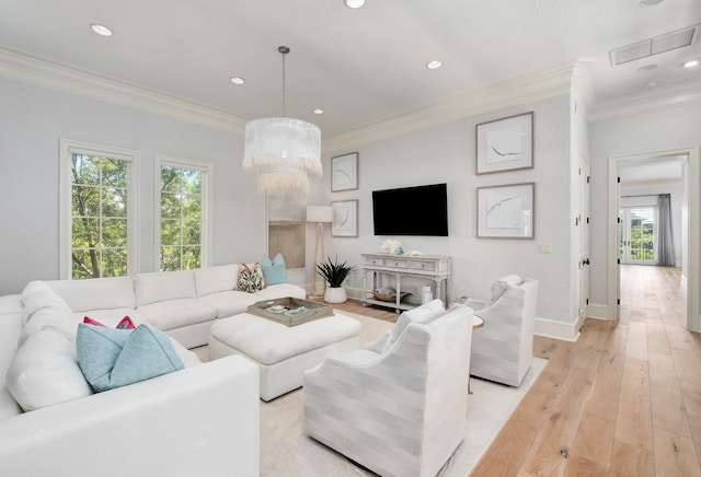 living room featuring light wood-type flooring, a wealth of natural light, and ornamental molding