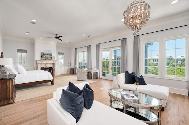 bedroom with access to exterior, ceiling fan with notable chandelier, and light wood-type flooring