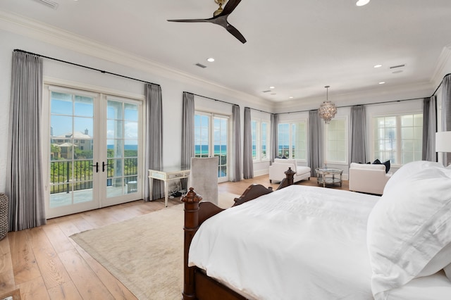 bedroom with access to exterior, ceiling fan with notable chandelier, light hardwood / wood-style flooring, and multiple windows