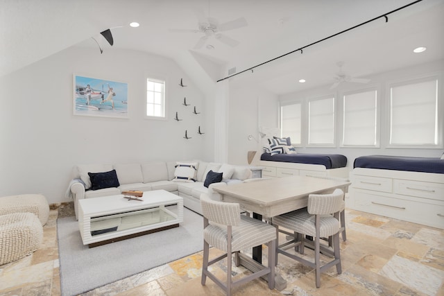 dining space with ceiling fan and lofted ceiling