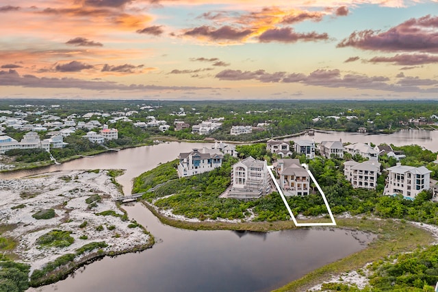 aerial view at dusk with a water view