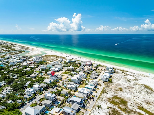 birds eye view of property featuring a water view and a beach view