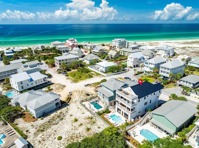 drone / aerial view with a water view and a beach view