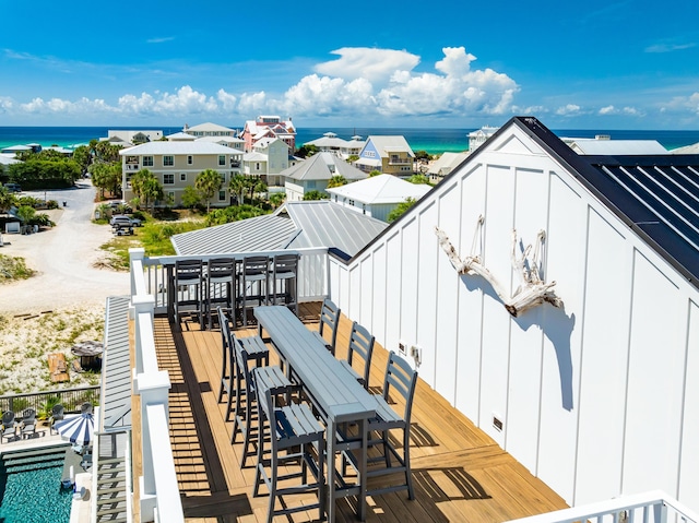 balcony featuring a bar and a water view