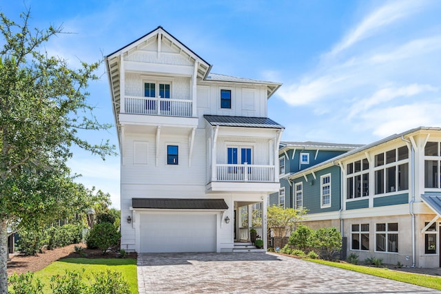 view of front facade featuring a garage and a balcony