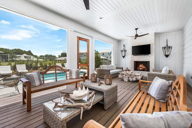 interior space with wooden ceiling, a large fireplace, and ceiling fan