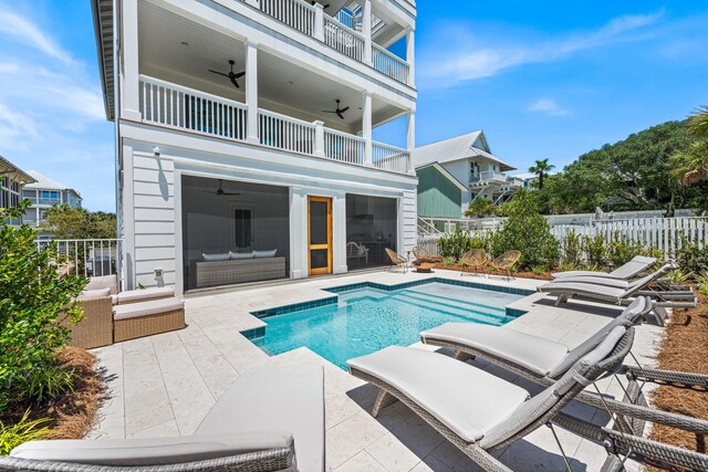 view of pool featuring an outdoor living space, a patio area, and ceiling fan