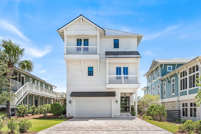 view of front of property with a garage and a balcony