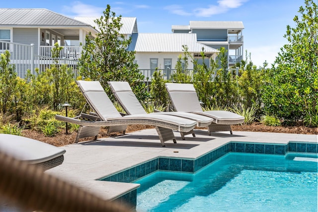 view of swimming pool with a patio