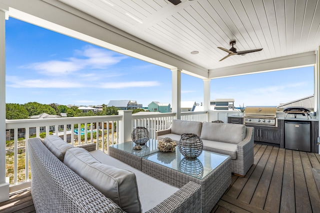 wooden deck with exterior kitchen, ceiling fan, outdoor lounge area, and grilling area