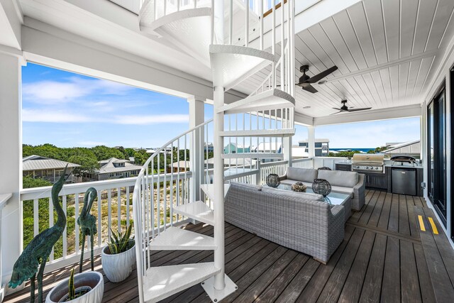 deck featuring grilling area, outdoor lounge area, ceiling fan, and exterior kitchen