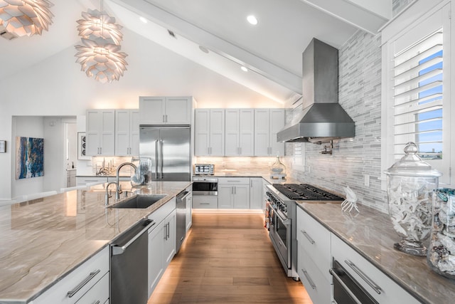 kitchen with sink, backsplash, high quality appliances, extractor fan, and lofted ceiling with beams