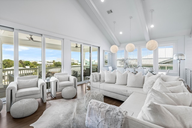 living room with a healthy amount of sunlight, dark hardwood / wood-style floors, and beamed ceiling