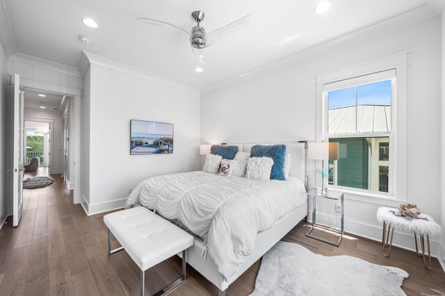 bedroom featuring ceiling fan, ornamental molding, and dark hardwood / wood-style flooring