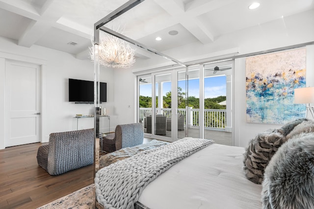 bedroom featuring dark hardwood / wood-style flooring, access to exterior, beam ceiling, and a notable chandelier