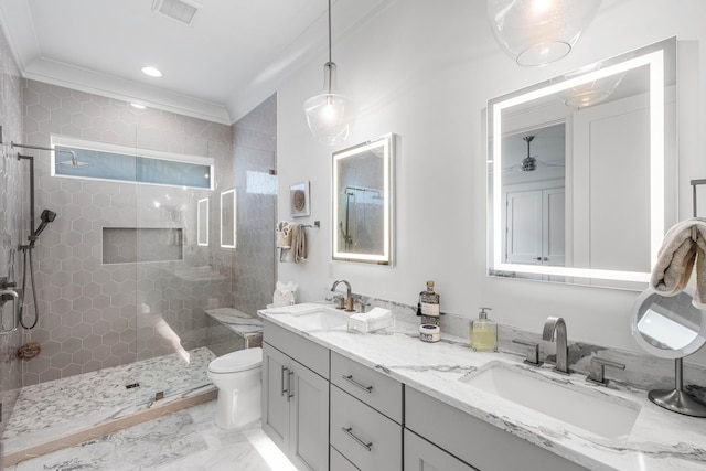 bathroom featuring crown molding, vanity, toilet, and a tile shower