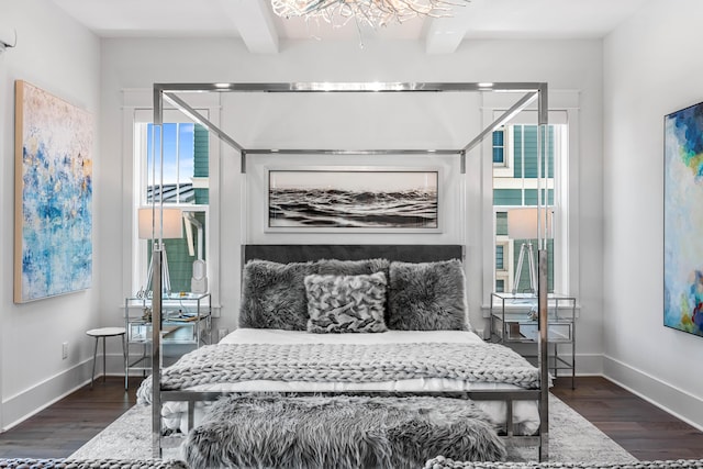 bedroom featuring beam ceiling and dark wood-type flooring