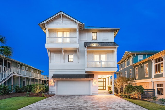 view of front of home featuring a garage and a balcony